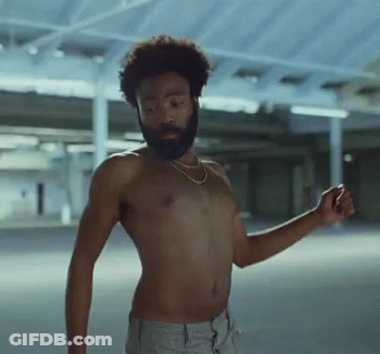 A Shirtless Man With A Beard Is Dancing In A Parking Garage GIF
