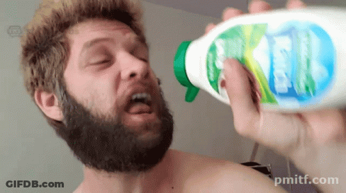 A Shirtless Man With A Beard Is Holding A Bottle Of Kleenex In His Right Hand GIF
