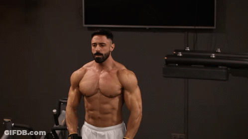 A Shirtless Man With A Beard Is Lifting A Barbell GIF
