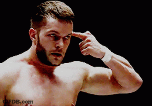 A Shirtless Man With A Beard Is Pointing His Finger At His Forehead GIF