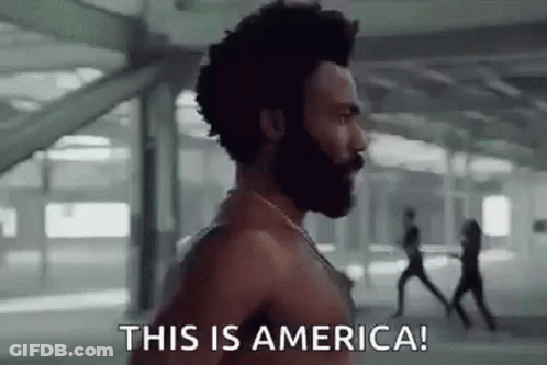 A Shirtless Man With A Beard Is Running In A Building And Saying `` This Is America ! '' GIF