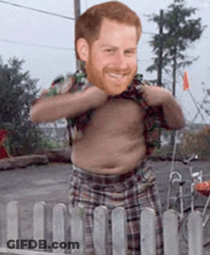 A Shirtless Man With A Beard Is Standing Behind A Fence GIF