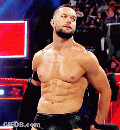 A Shirtless Man With A Beard Is Standing In A Ring . GIF