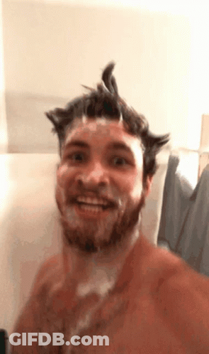 A Shirtless Man With A Beard Is Taking A Shower GIF