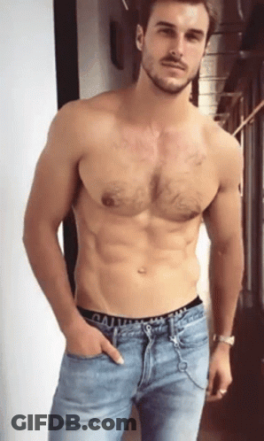 A Shirtless Man With A Beard Is Wearing A Pair Of Calvin Klein Jeans GIF