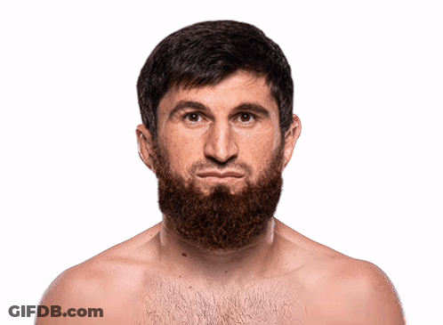 A Shirtless Man With A Beard Looks At The Camera With A Serious Look On His Face GIF