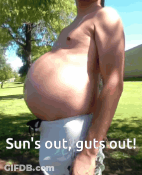 A Shirtless Man With A Large Belly Is Standing In A Park With The Words Sun 'S Out Guts Out GIF