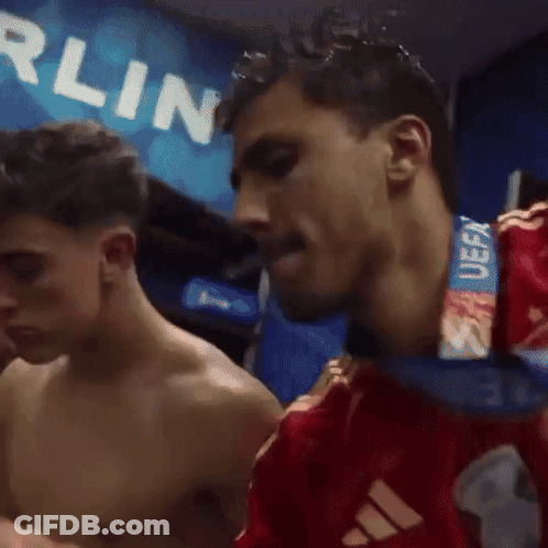 A Shirtless Man With A Medal Around His Neck That Says Uefa On It GIF