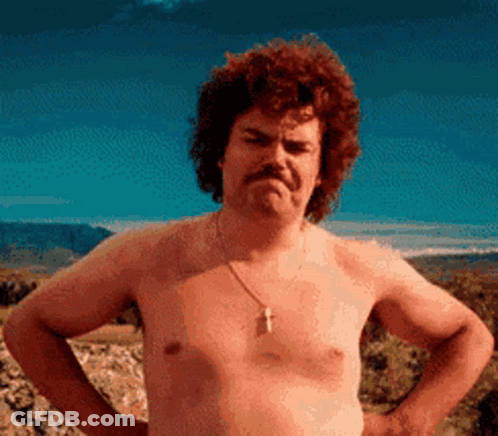A Shirtless Man With A Moustache Is Standing With His Hands On His Hips . GIF