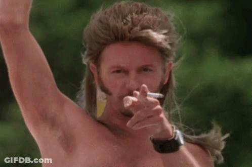 A Shirtless Man With A Mullet Is Smoking A Cigarette . GIF