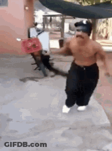 A Shirtless Man With A Mustache Is Running With A Motorcycle In The Background . GIF