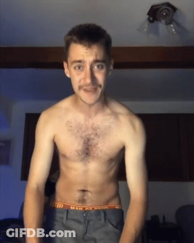A Shirtless Man With A Mustache Is Wearing A Pair Of Underwear That Says Mail Of America GIF