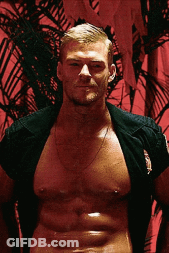 A Shirtless Man With A Palm Tree In The Background Is Wearing A Black Shirt GIF