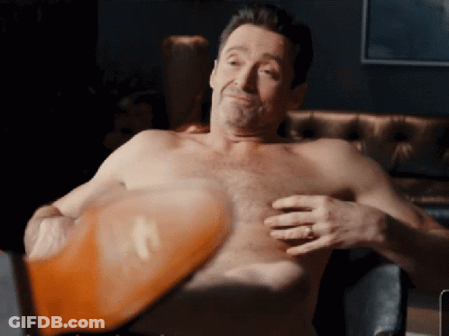 A Shirtless Man With A Ring On His Finger Holds His Chest GIF