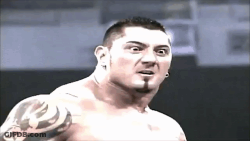 A Shirtless Man With A Tattoo On His Arm Is Making A Surprised Face GIF