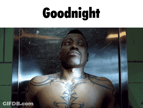 A Shirtless Man With A Tattoo On His Chest Is Laying In A Coffin With The Words Goodnight Below Him GIF
