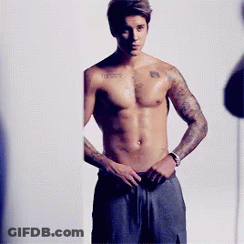 A Shirtless Man With A Tattoo On His Chest That Says ' Infinity ' GIF