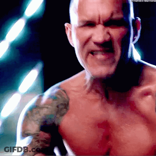 A Shirtless Man With A Tattoo On His Shoulder Is Looking At The Camera GIF