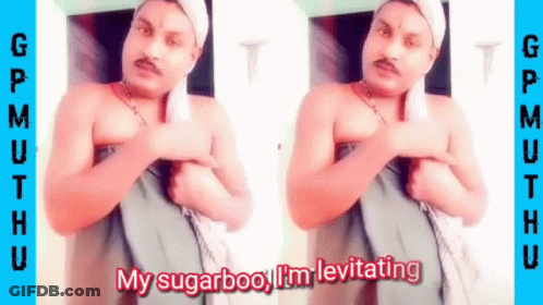 A Shirtless Man With A Towel Around His Head Is Standing In Front Of A Door . GIF