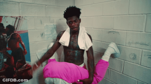 A Shirtless Man With A Towel Around His Neck Holds A Woman In His Arms GIF
