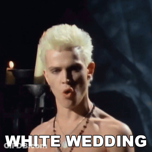 A Shirtless Man With Blonde Hair Is Singing A Song Called White Wedding GIF