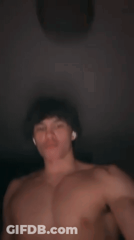 A Shirtless Man With Ear Buds On His Ears GIF
