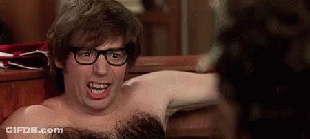 A Shirtless Man With Glasses Is Making A Funny Face While Sitting On A Bench . GIF
