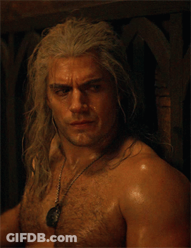 A Shirtless Man With Gray Hair And A Necklace Around His Neck GIF