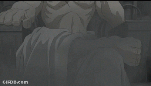 A Shirtless Man With Long Blonde Hair Is Sitting In A Chair GIF