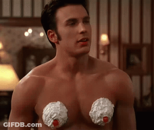 A Shirtless Man With Whipped Cream On His Chest Looks At The Camera GIF