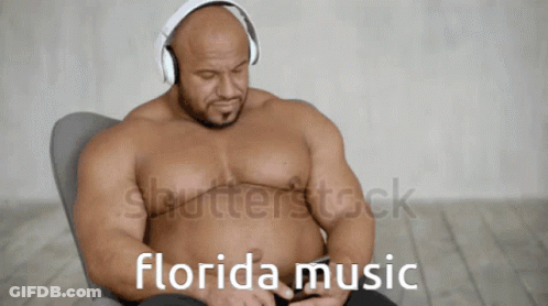 A Shirtless Muscular Man Wearing Headphones Is Listening To Florida Music GIF