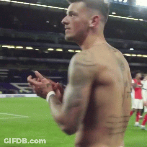 A Shirtless Soccer Player Is Clapping His Hands On The Field GIF