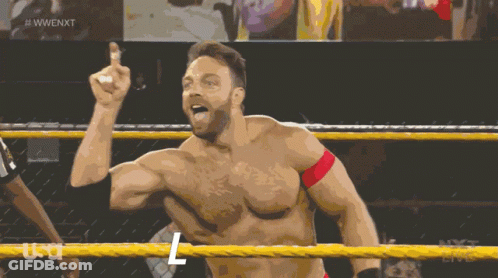 A Shirtless Wrestler In A Wrestling Ring With The Letters L On His Chest GIF