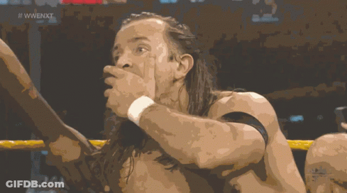 A Shirtless Wrestler In A Wrestling Ring With The Words Next Live Below Him GIF