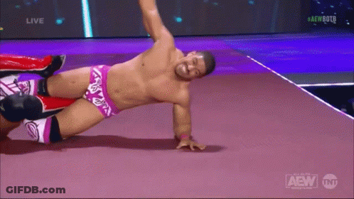 A Shirtless Wrestler Is Laying On The Floor During A Live Aew Event GIF
