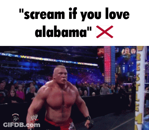 A Shirtless Wrestler Is Screaming In Front Of A Crowd With The Words " Scream If You Love Alabama " GIF
