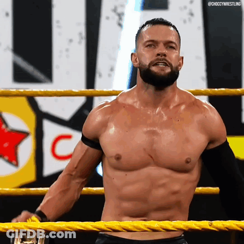 A Shirtless Wrestler Is Standing In A Wrestling Ring With The Word Choccy Wrestling On The Bottom Right GIF