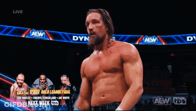 A Shirtless Wrestler Is Standing In Front Of A Banner That Says Aew GIF