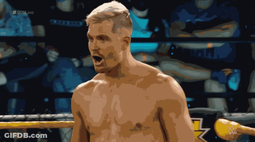 A Shirtless Wrestler Stands In A Ring With The Hashtag # 205Live GIF