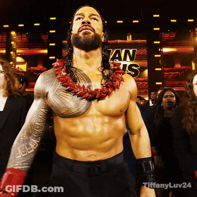A Shirtless Wrestler Stands In Front Of A Sign That Says ' An Is ' On It GIF