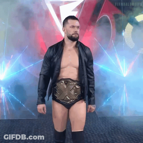 A Shirtless Wrestler Wearing A Belt With The Letters X On It GIF