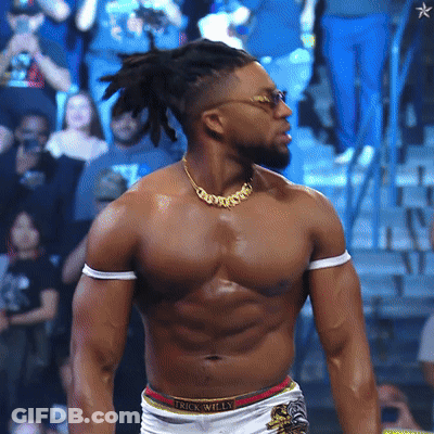A Shirtless Wrestler Wearing A Necklace That Says Trick Willy GIF