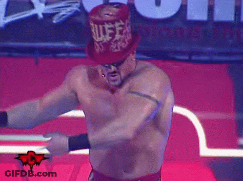 A Shirtless Wrestler Wearing A Red Top Hat With The Word Rules Written On It GIF