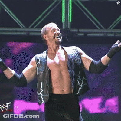 A Shirtless Wrestler Wearing A Vest That Says ' Pun ' On It GIF