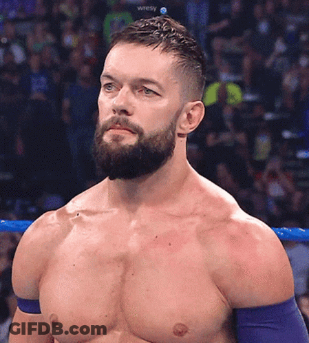 A Shirtless Wrestler With A Beard Is Standing In A Ring GIF