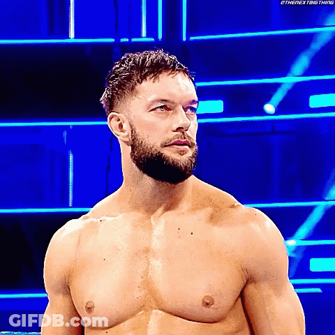 A Shirtless Wrestler With A Beard Is Standing In A Wrestling Ring . GIF