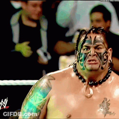 A Shirtless Wrestler With A Tattoo On His Arm And Face Has The Letter N On His Chest GIF