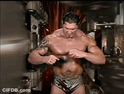 A Shirtless Wrestler With A Tattoo On His Stomach GIF