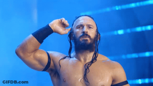 A Shirtless Wrestler With Dreadlocks And A Black Band Around His Wrist GIF