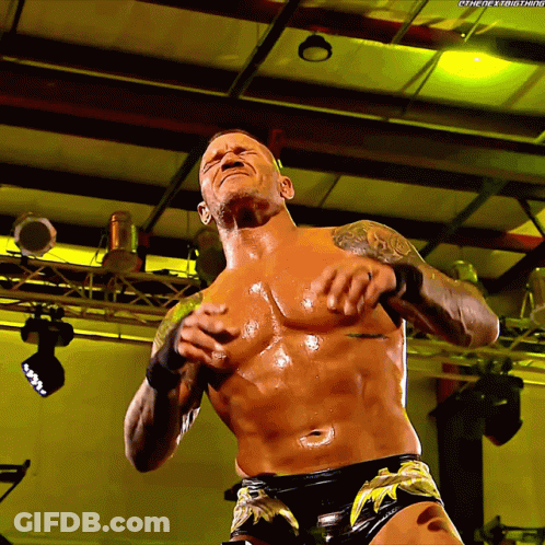 A Shirtless Wrestler With The Hashtag #Thenextbig Thing Written On The Bottom GIF